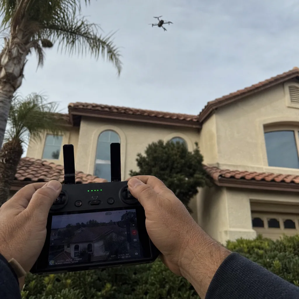Inspection.re drone pilot performing aerial roof inspection on a California home