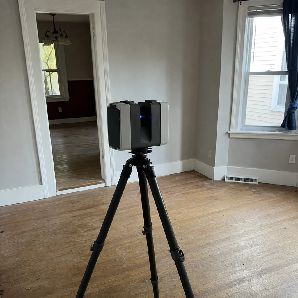 Inspection.re LIDAR 3D laser scanner on a tripod capturing floor plan measurements during a home inspection